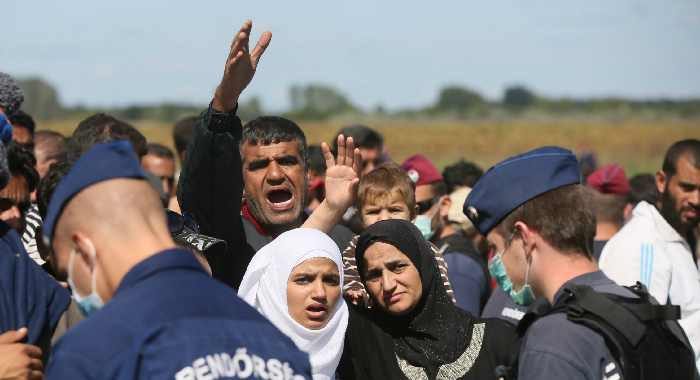Hungarian police and migrants at the border town of Roszke, Hungary, September 7, 2015. Paul Hackett/In Pictures/Corbis