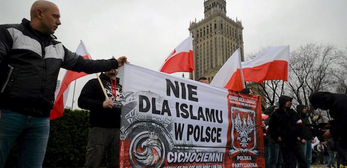 Far-right protesters carry banner reading “No Islam in Poland”