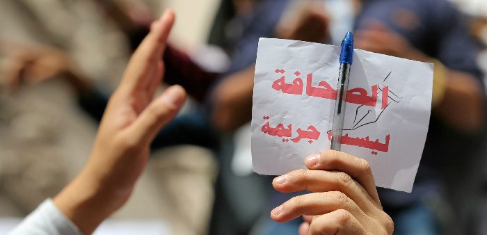 Journalist holding a sign, ''Journalism is not a crime'', during a protest at the Press Syndicate in Cairo, May 4, 2016. Reuters/Staff