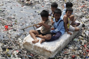 Children playing in a polluted river, Jakarta, Sept. 19, 2012. Enny Nuraheni/Reuters