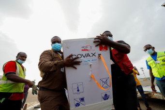 Workers carry boxes of Oxford/AstraZeneca coronavirus disease (COVID-19) vaccines, redeployed from the Democratic Republic of Congo, at the Kotoka International Airport in Accra, Ghana, May 7, 2021. REUTERS/Francis Kokoroko - RC2UAN954LBE